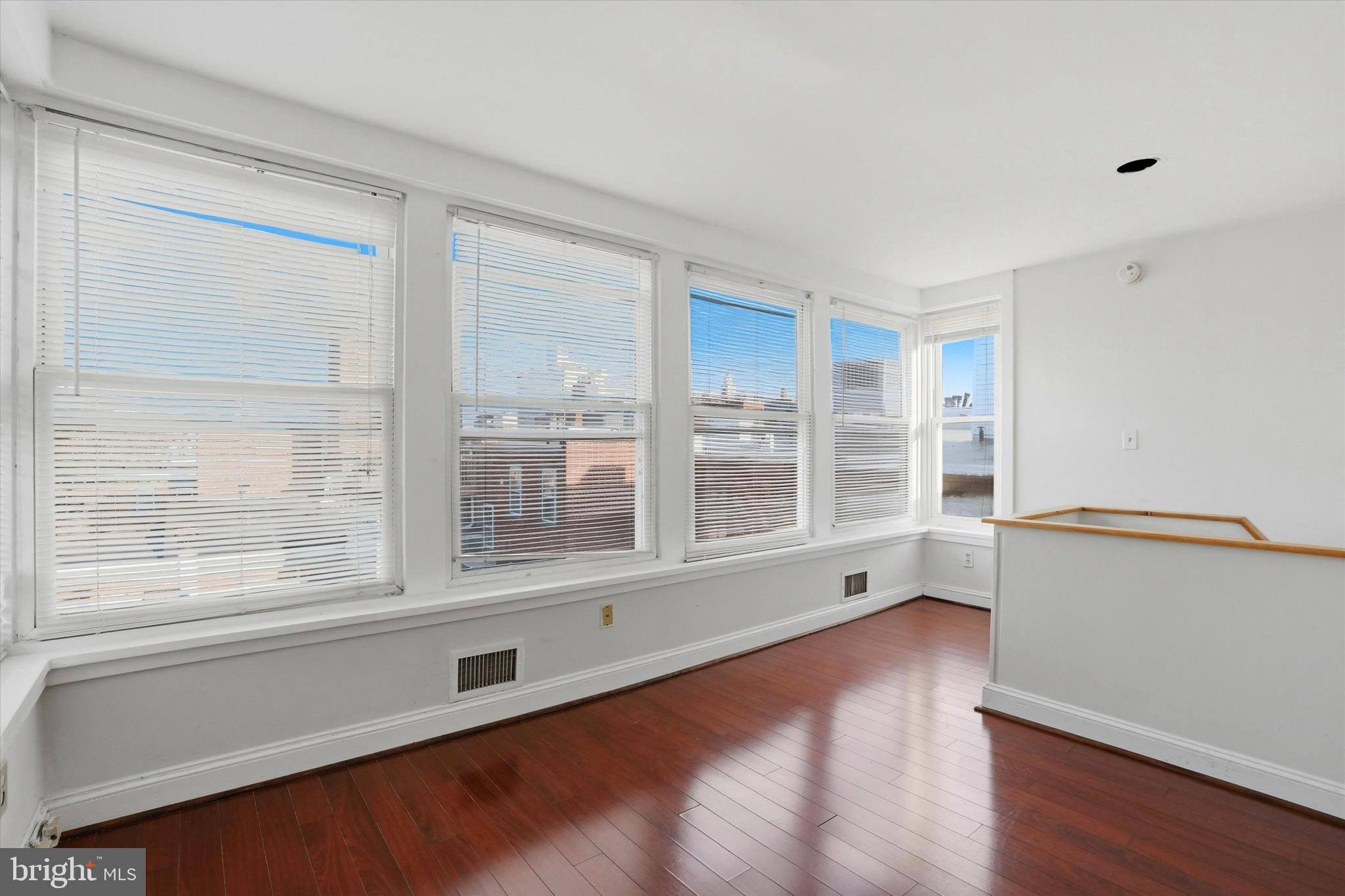 1713 Green Street, Unit 5 Philadelphia, PA 19130 - Photo 13 of 15 a view of an empty room with wooden floor and a window