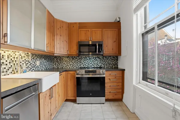 a kitchen with stainless steel appliances granite countertop a stove and a sink