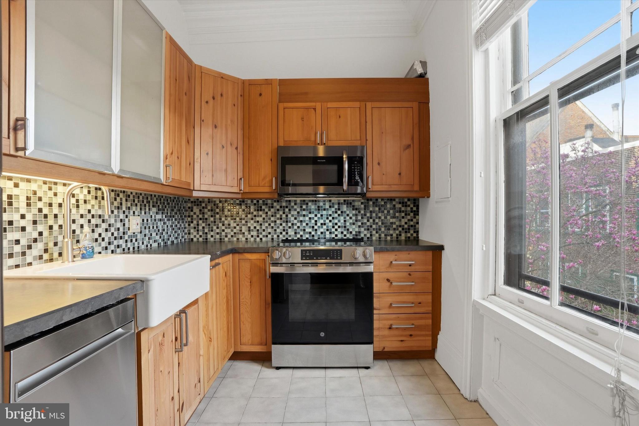 1713 Green Street, Unit 5 Philadelphia, PA 19130 - Photo 5 of 15 a kitchen with stainless steel appliances granite countertop a stove and a sink