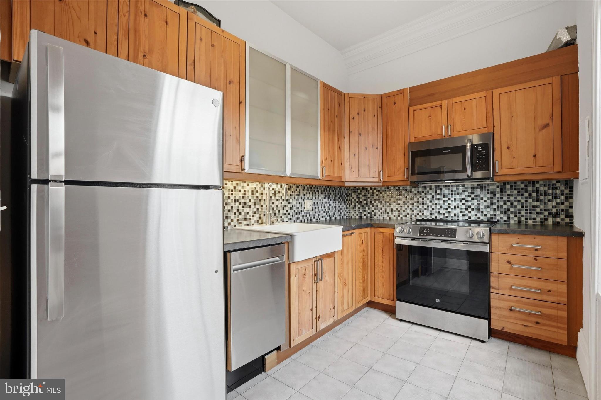 1713 Green Street, Unit 5 Philadelphia, PA 19130 - Photo 6 of 15 a white refrigerator freezer sitting in a kitchen