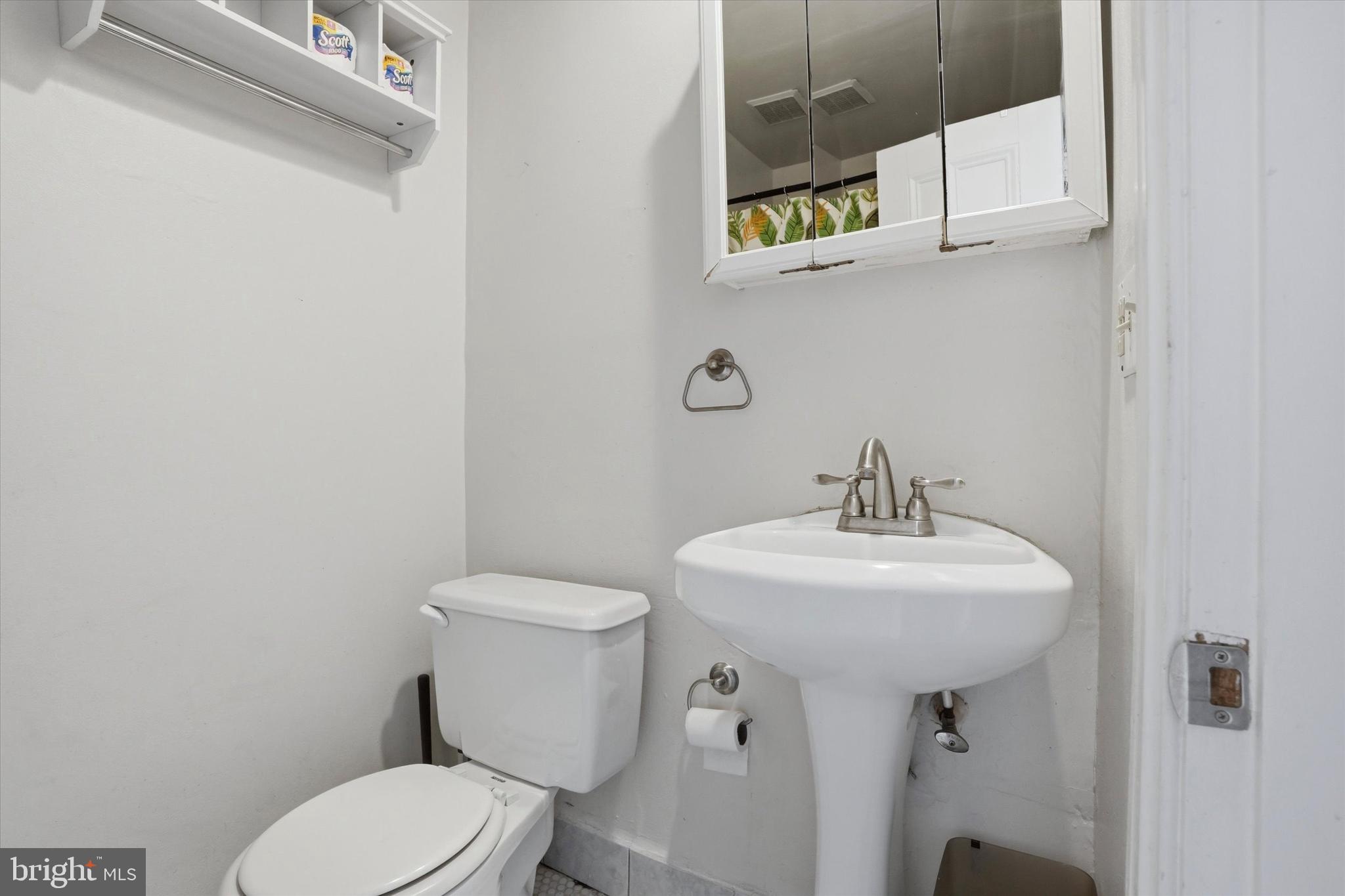 1713 Green Street, Unit 5 Philadelphia, PA 19130 - Photo 10 of 15 a bathroom with a sink toilet and a mirror