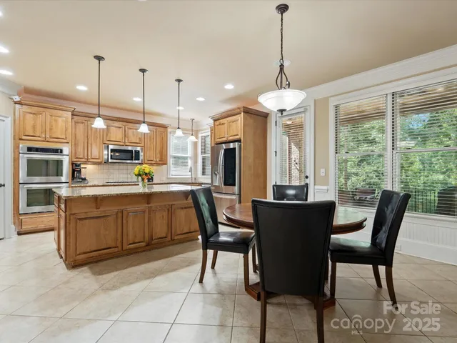 a living room with kitchen island furniture and a chandelier