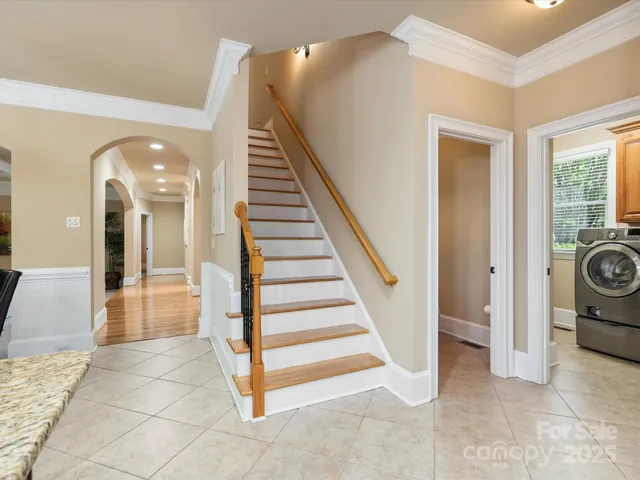 a view of entryway with wooden floor and stairs