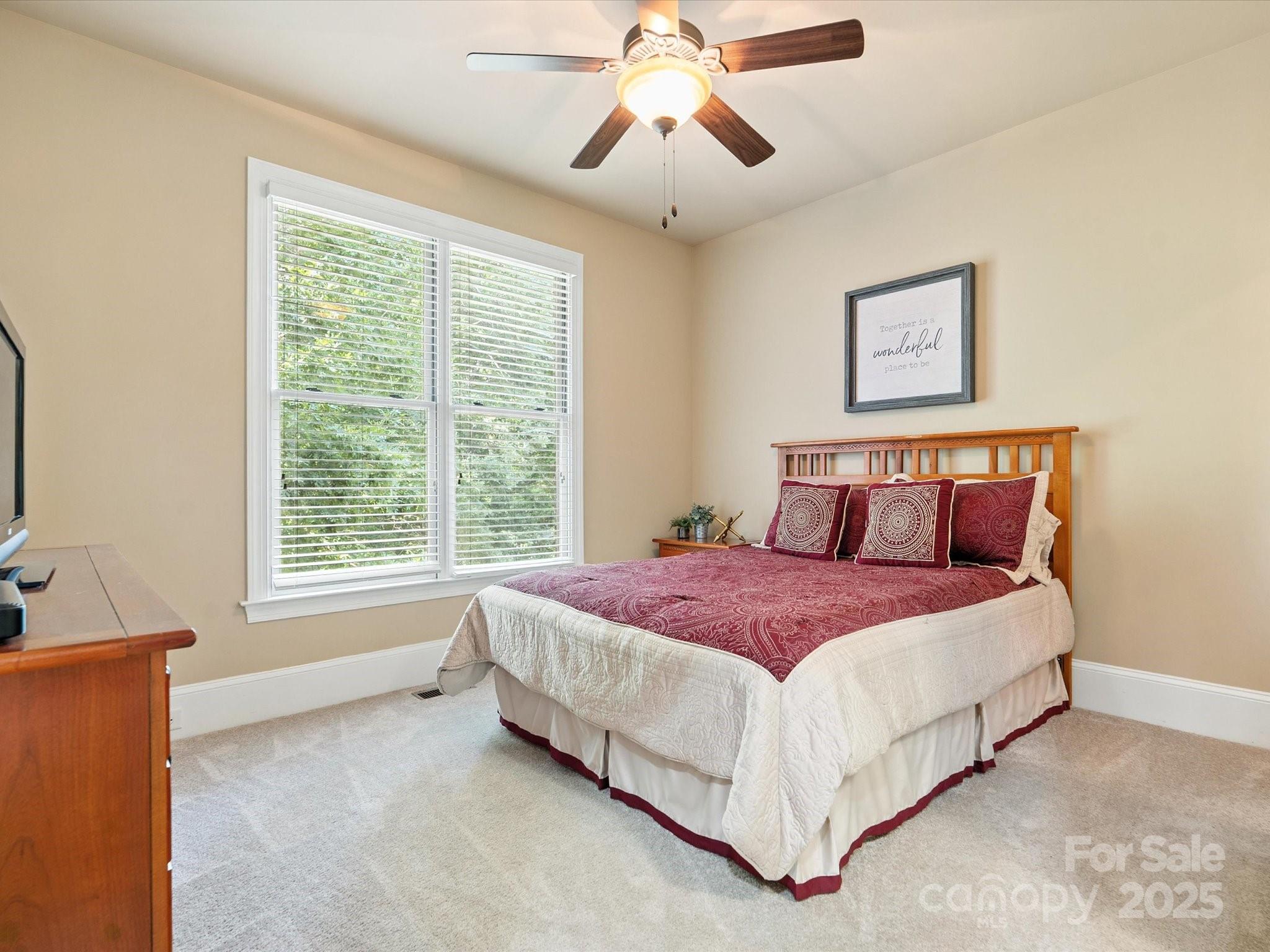 8407 Rolling Fields Road Mint Hill, NC 28227 - Photo 15 of 48 a spacious bedroom with a bed and a window