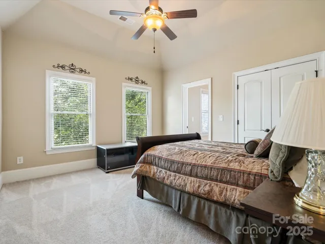 a bedroom with a bed and a chandelier