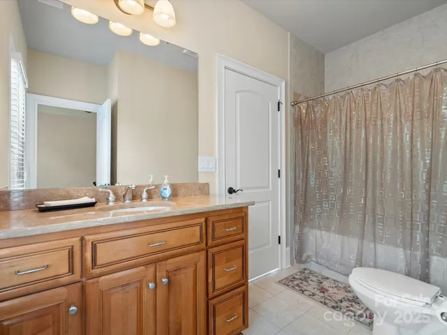 a bathroom with a double vanity sink mirror and toilet
