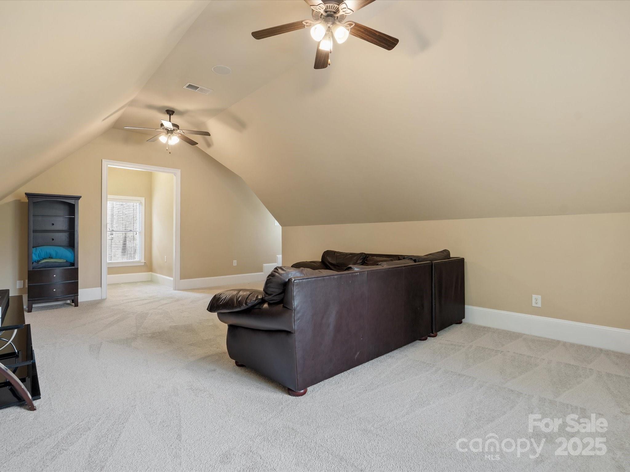 8407 Rolling Fields Road Mint Hill, NC 28227 - Photo 29 of 48 a room with furniture and a ceiling fan