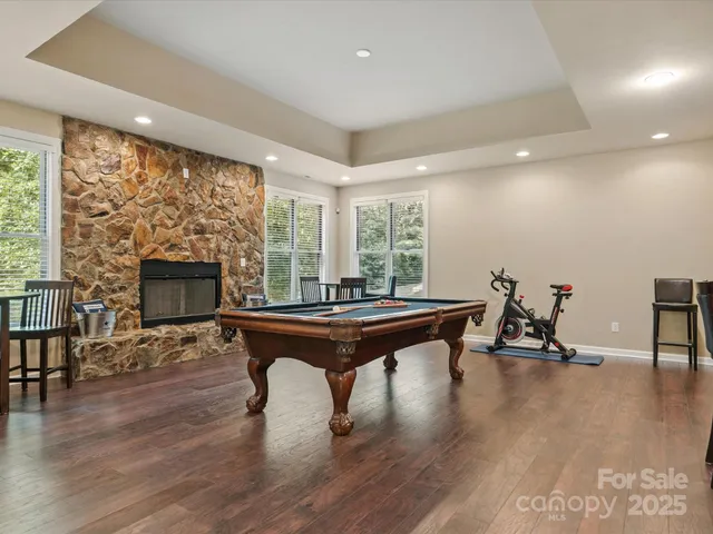 a living room with furniture a fireplace and wooden floor