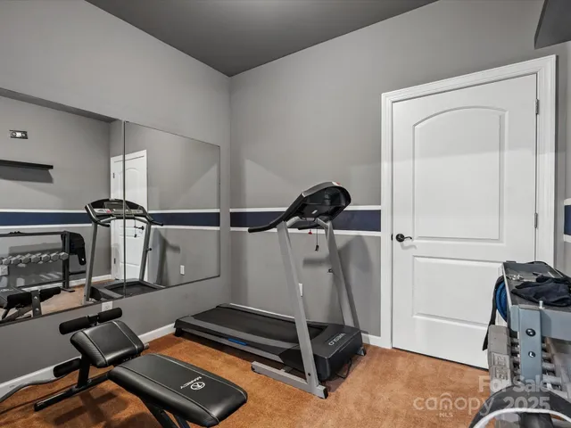 a room with gym equipment and a mirror