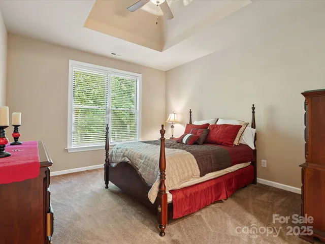 a bed sitting in a bedroom next to a window