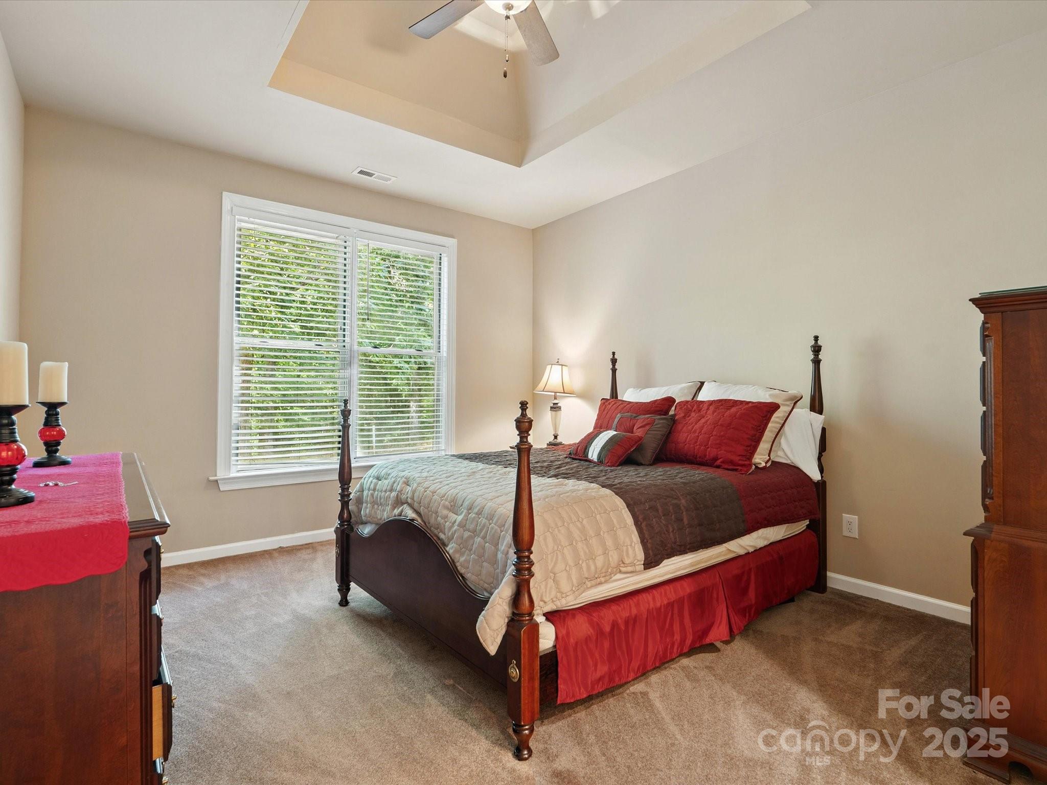 8407 Rolling Fields Road Mint Hill, NC 28227 - Photo 40 of 48 a bed sitting in a bedroom next to a window