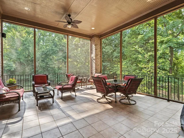 a living room with patio furniture and a floor to ceiling window