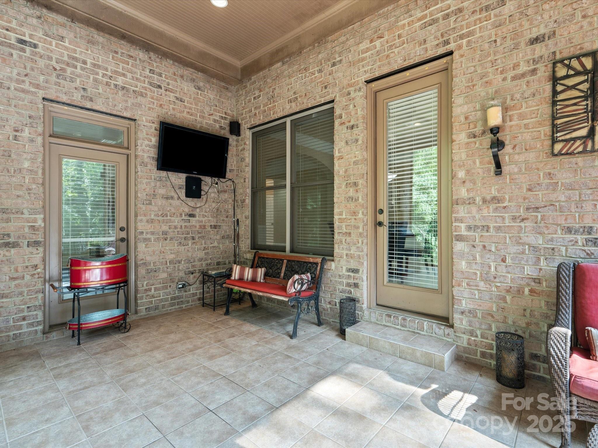 8407 Rolling Fields Road Mint Hill, NC 28227 - Photo 43 of 48 a living room with furniture a flat screen tv and a fireplace