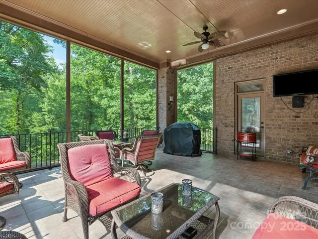 a outdoor living space with furniture potted plant and a floor to ceiling window