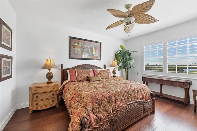a bedroom with a bed potted plant and a window