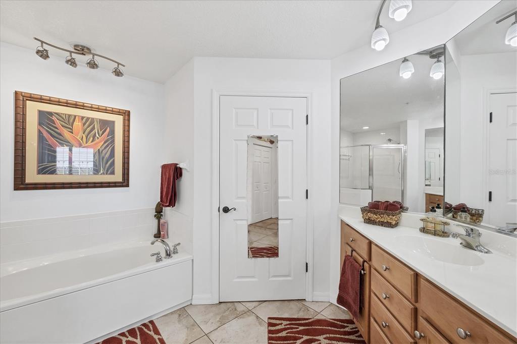 13113 Gasparilla Road, Unit A305 Placida, FL 33946 - Photo 17 of 29 a bathroom with a tub sink and mirror