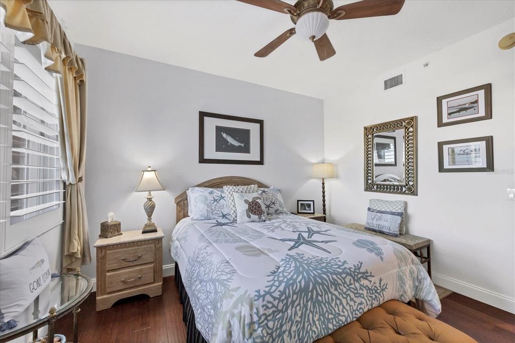 13113 Gasparilla Road, Unit A305 Placida, FL 33946 - Photo 19 of 29 a bedroom with a bed and a chandelier