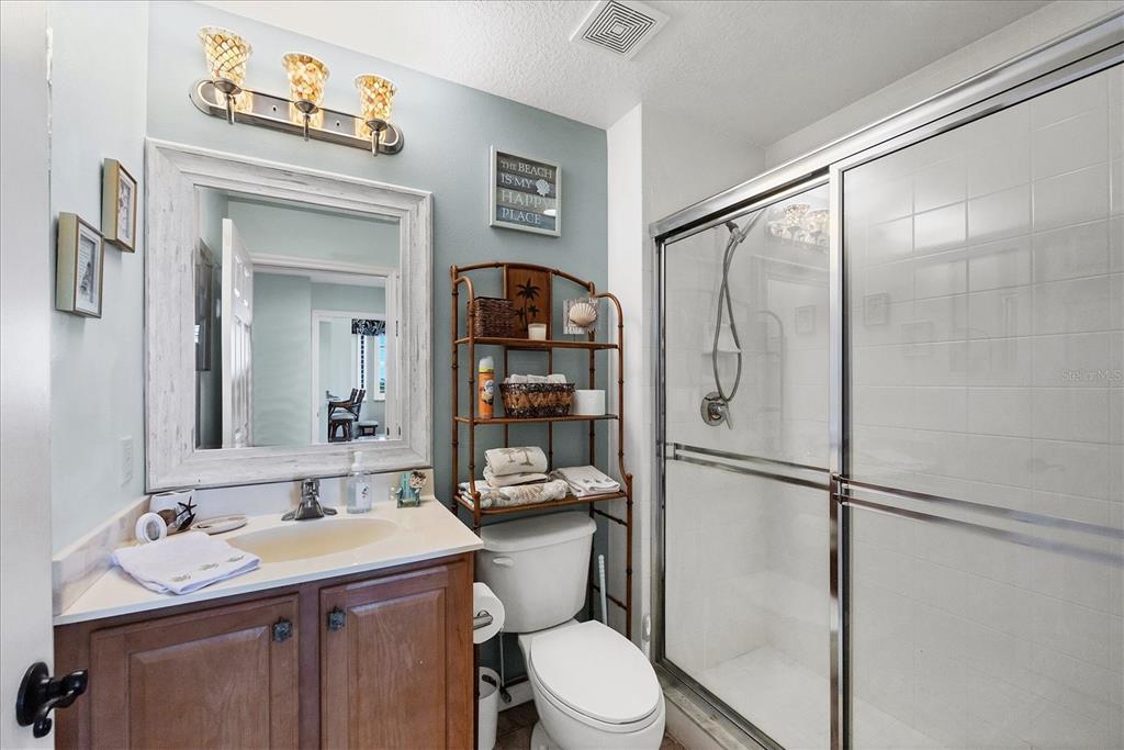 13113 Gasparilla Road, Unit A305 Placida, FL 33946 - Photo 20 of 29 a bathroom with a sink toilet and shower