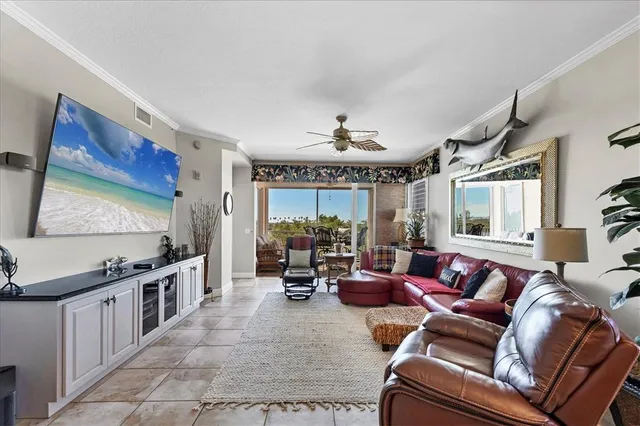 a living room with furniture tv and a large window