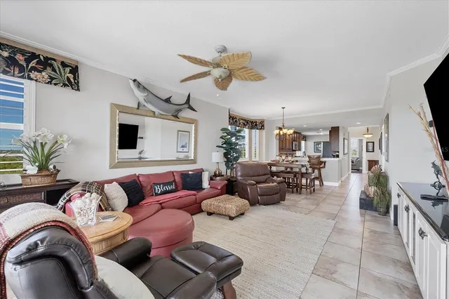 a living room with furniture kitchen view and a window