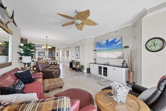 a living room with furniture and a chandelier