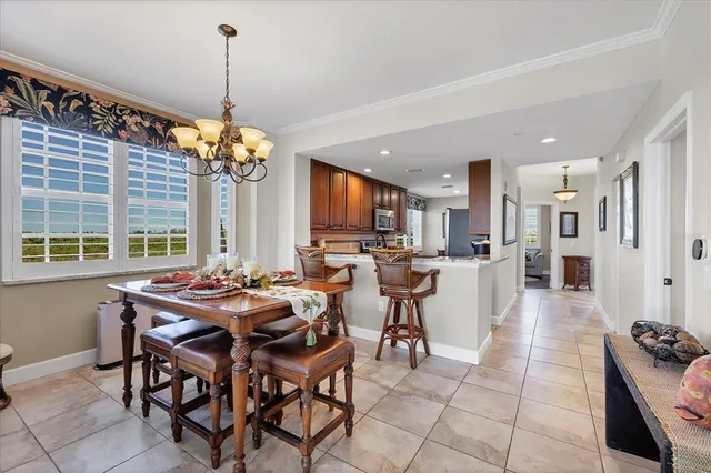 a kitchen with stainless steel appliances kitchen island granite countertop a stove a refrigerator a oven a sink dishwasher and white cabinets with wooden floor