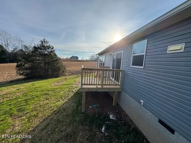 a view of balcony with wooden floor and fence