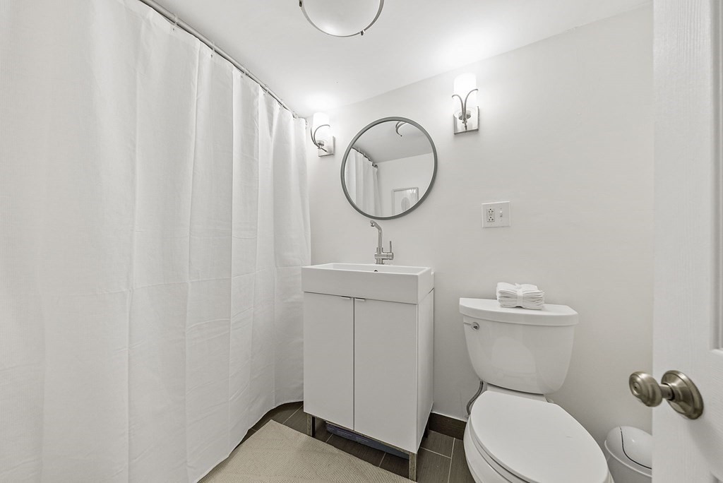 15 Ridgehill Road Canton, MA 02021 - Photo 16 of 30 a bathroom with a toilet a sink and a mirror