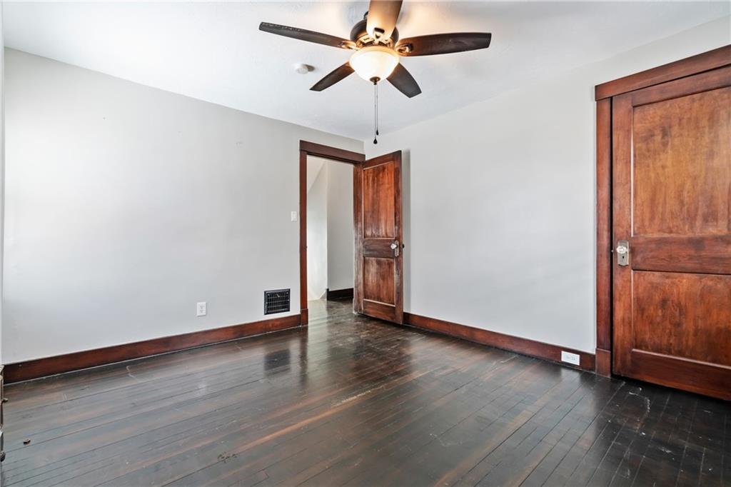 3409 Brownsville Road Pittsburgh, PA 15227 - Photo 16 of 28 a view of an empty room with window and wooden floor