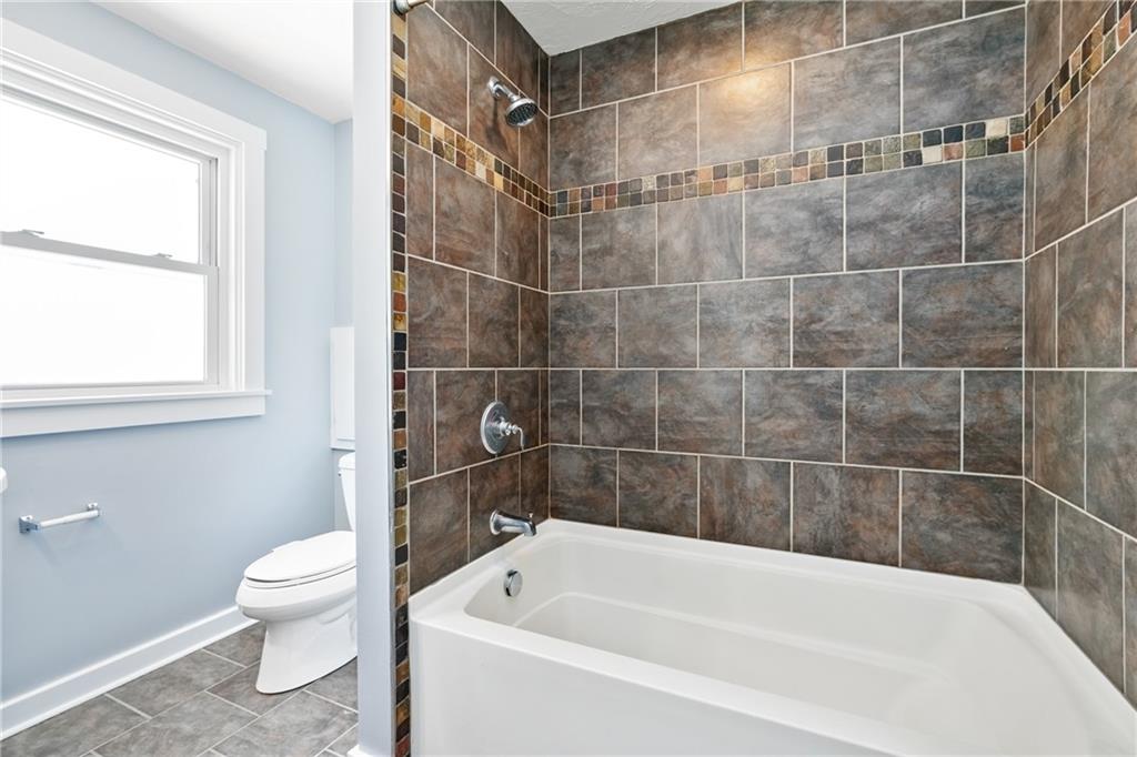 3409 Brownsville Road Pittsburgh, PA 15227 - Photo 17 of 28 a bathroom with a bathtub and a toilet