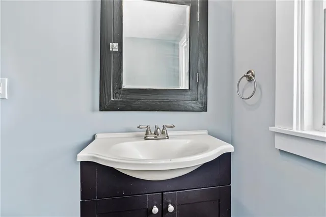 a bathroom with a sink and a mirror
