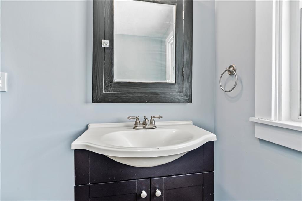 3409 Brownsville Road Pittsburgh, PA 15227 - Photo 18 of 28 a bathroom with a sink and a mirror
