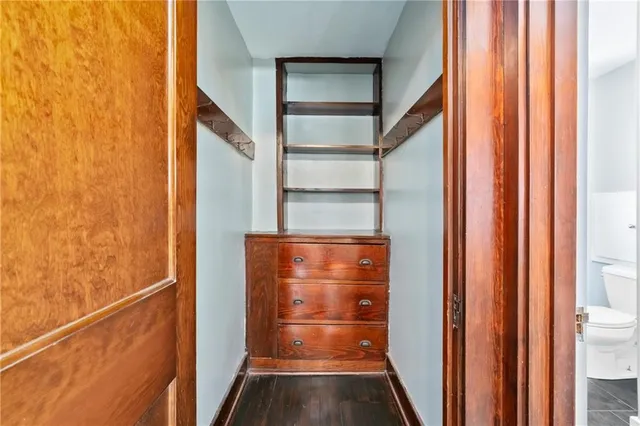 a view of water heater room with wooden floor