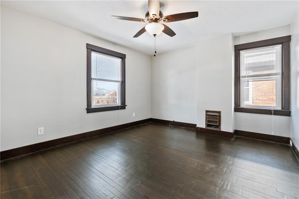 3409 Brownsville Road Pittsburgh, PA 15227 - Photo 20 of 28 a view of an empty room with window and wooden floor