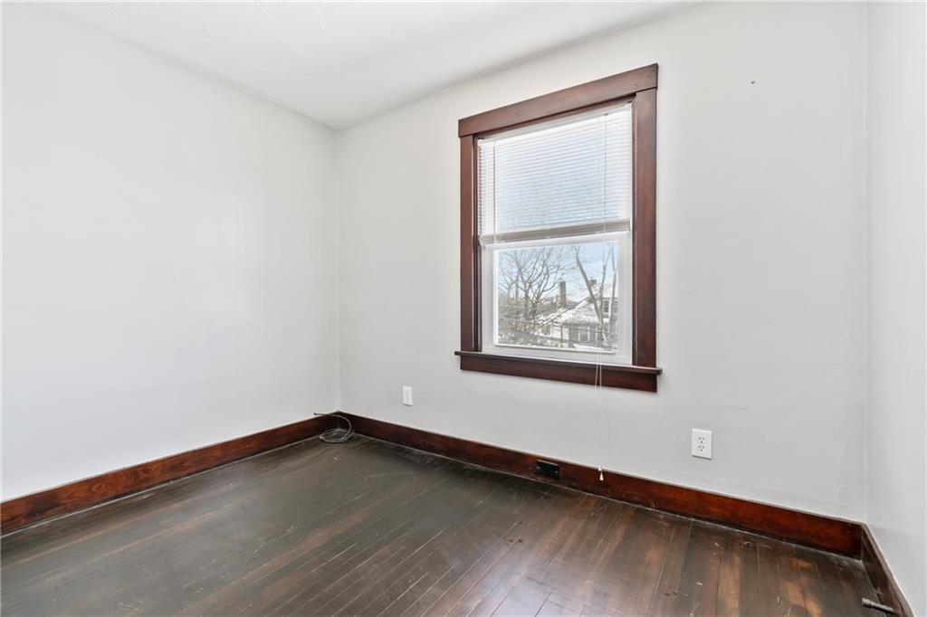 3409 Brownsville Road Pittsburgh, PA 15227 - Photo 22 of 28 a view of an empty room with wooden floor and a window