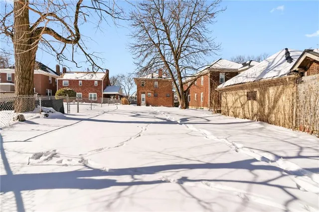 a view of a house with snow on the road