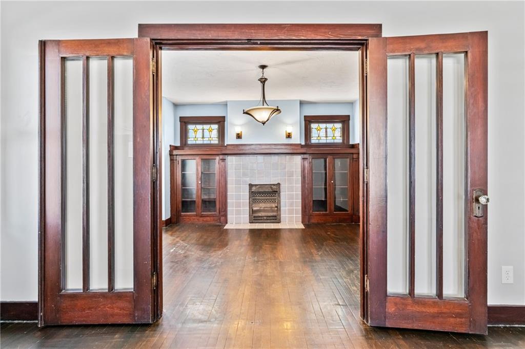 3409 Brownsville Road Pittsburgh, PA 15227 - Photo 9 of 28 a view of an entryway with wooden floor and a fireplace