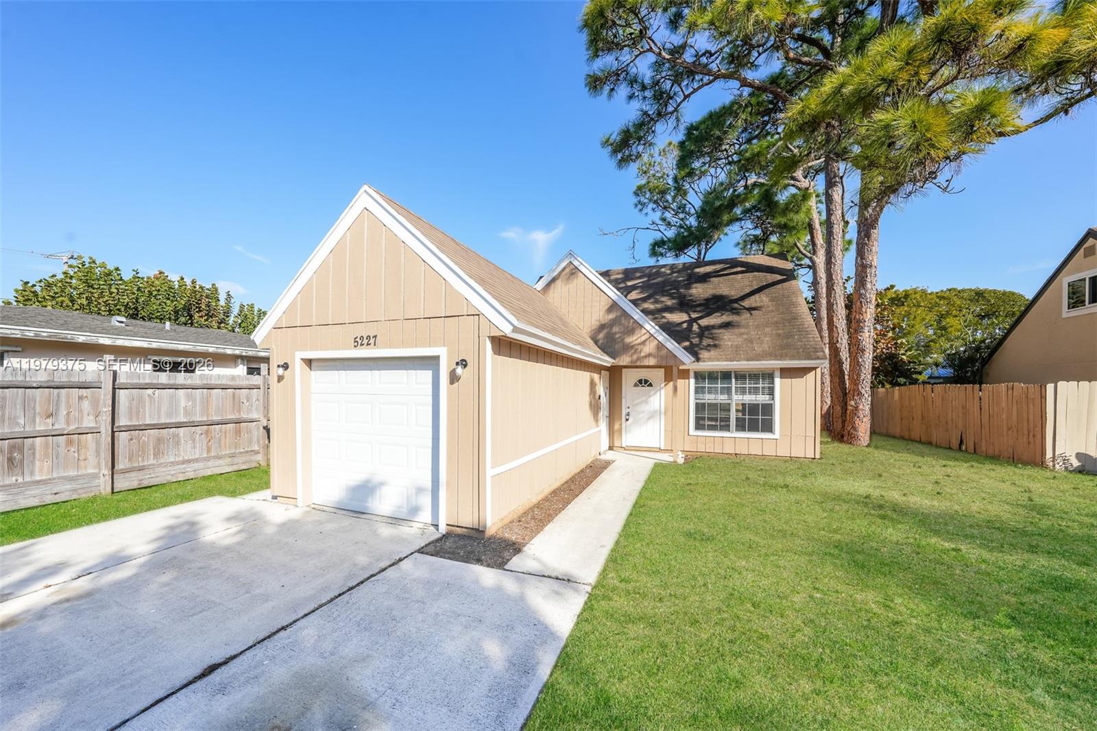 5227 Adams Road Delray Beach, FL 33484 - Photo 1 of 18 a view of a house with a yard and porch