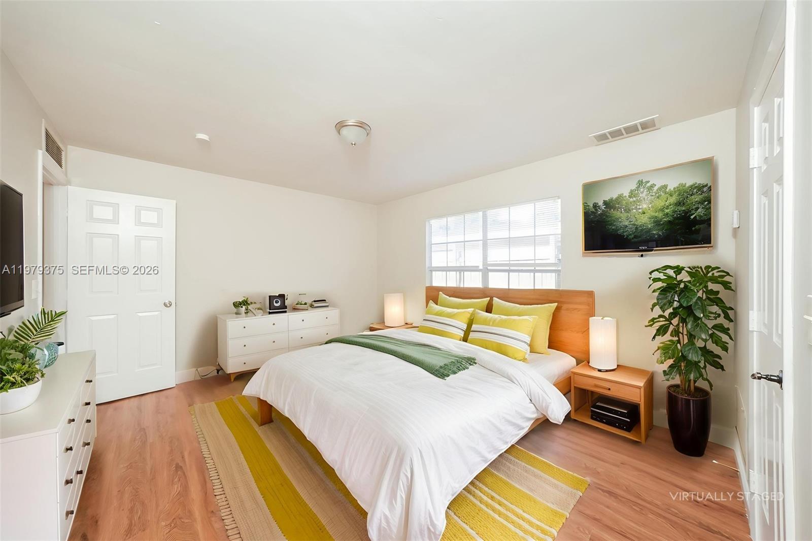 5227 Adams Road Delray Beach, FL 33484 - Photo 11 of 18 a bedroom with a bed and a flat screen tv