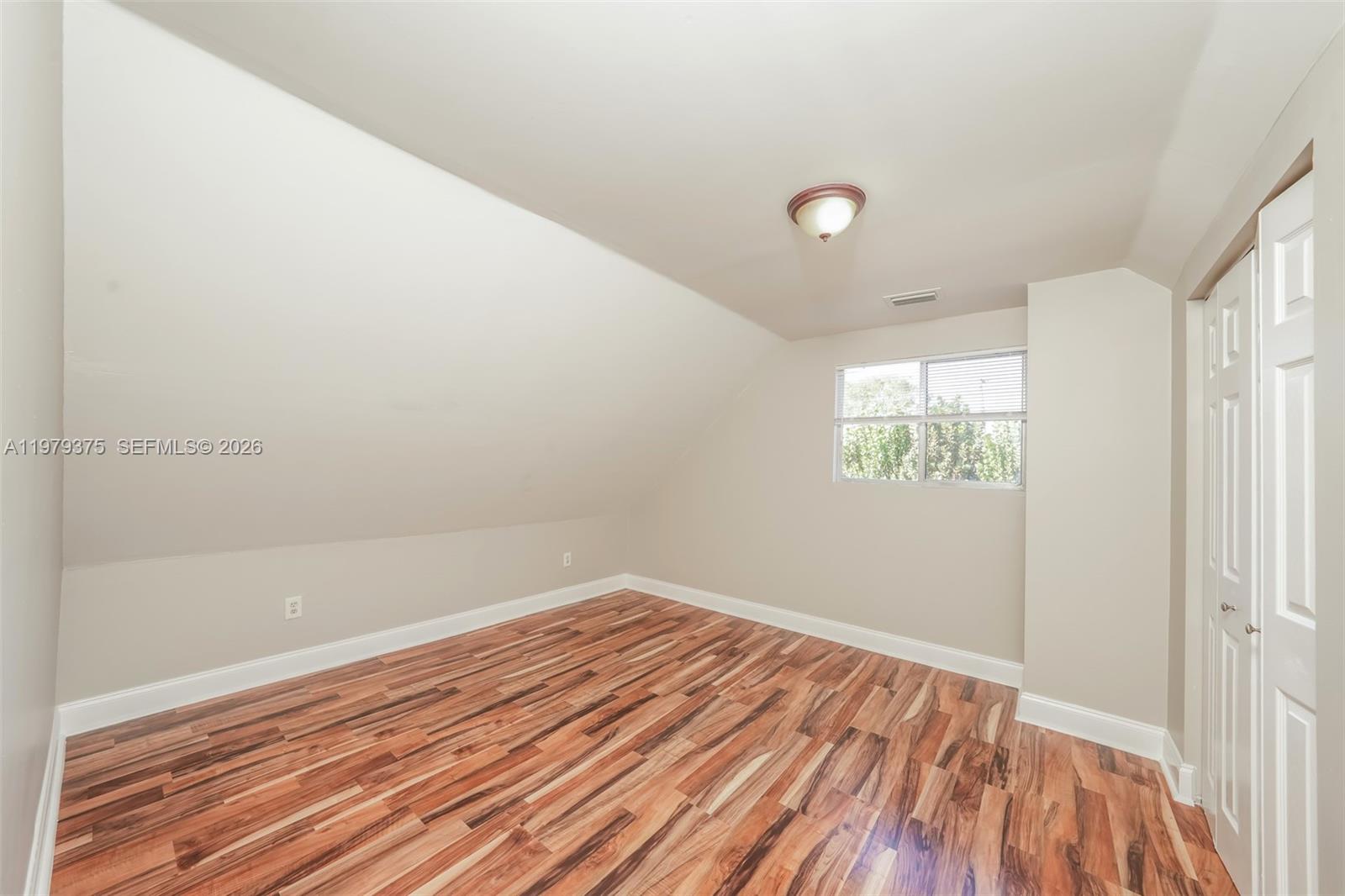 5227 Adams Road Delray Beach, FL 33484 - Photo 13 of 18 a view of empty room with wooden floor
