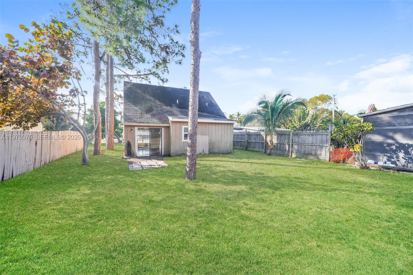 5227 Adams Road Delray Beach, FL 33484 - Photo 18 of 18 a view of an house with backyard space and garden