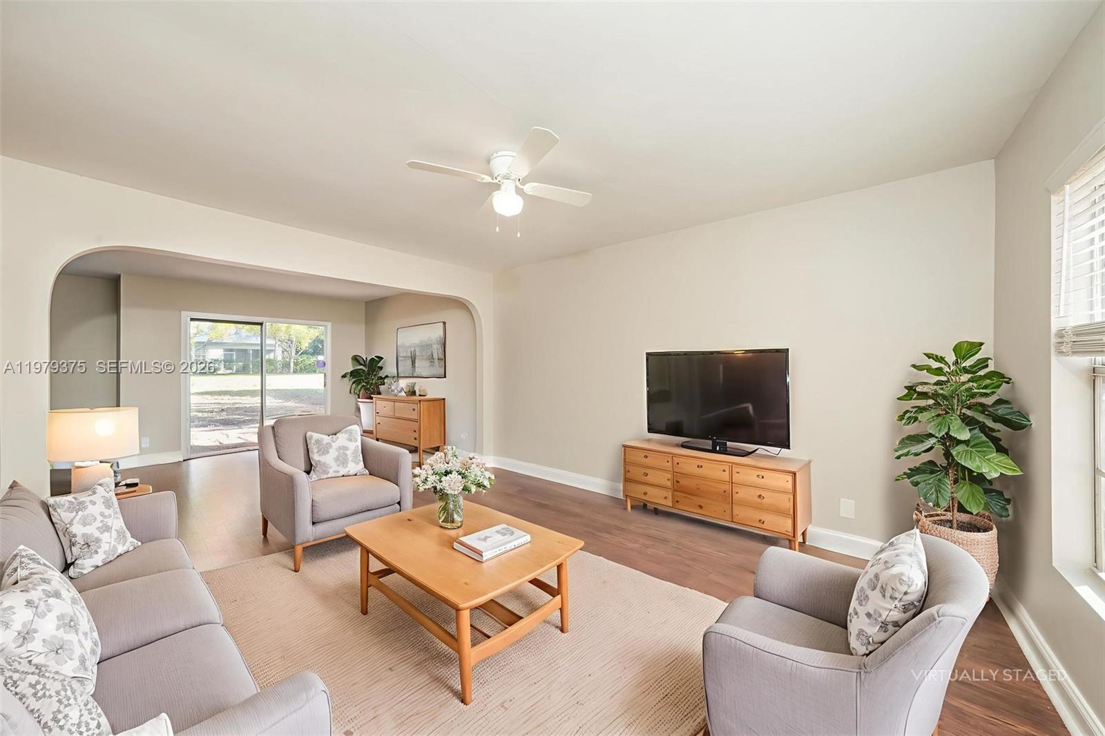 5227 Adams Road Delray Beach, FL 33484 - Photo 3 of 18 a living room with furniture and a flat screen tv