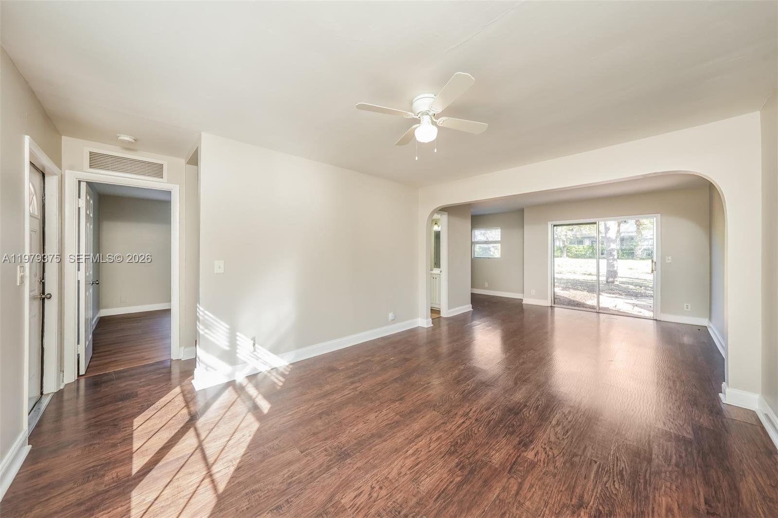 5227 Adams Road Delray Beach, FL 33484 - Photo 4 of 18 a view of empty room with wooden floor and fan