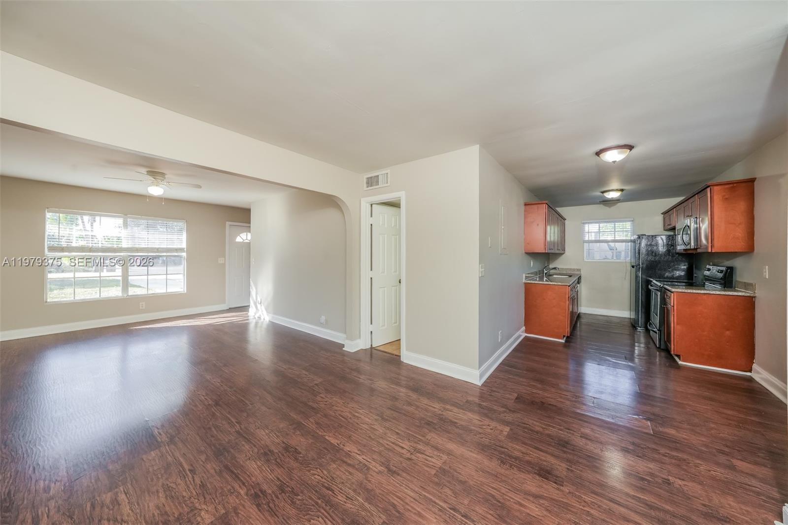 5227 Adams Road Delray Beach, FL 33484 - Photo 6 of 18 a view of kitchen with furniture and wooden floor