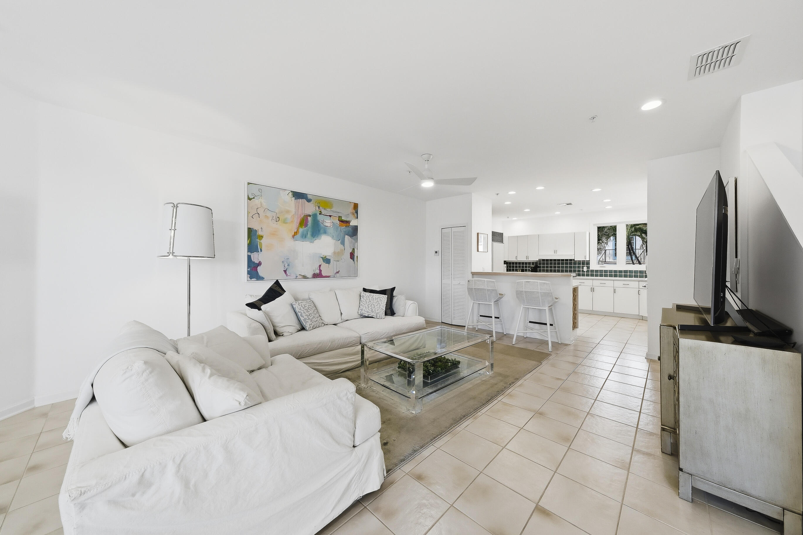 4535 Coquina Road Ocean Ridge, FL 33435 - Photo 13 of 45 a living room with furniture a flat screen tv and kitchen view