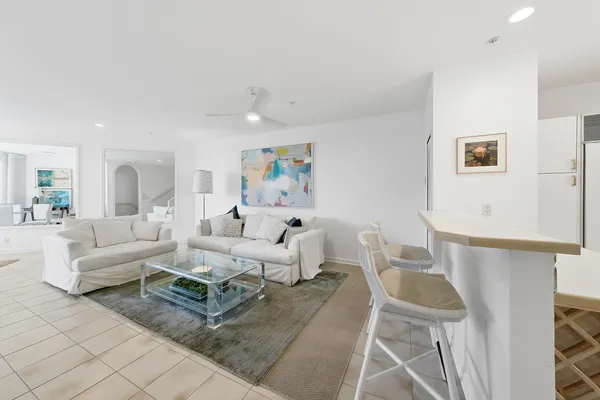 a kitchen with white cabinets a sink and white appliances