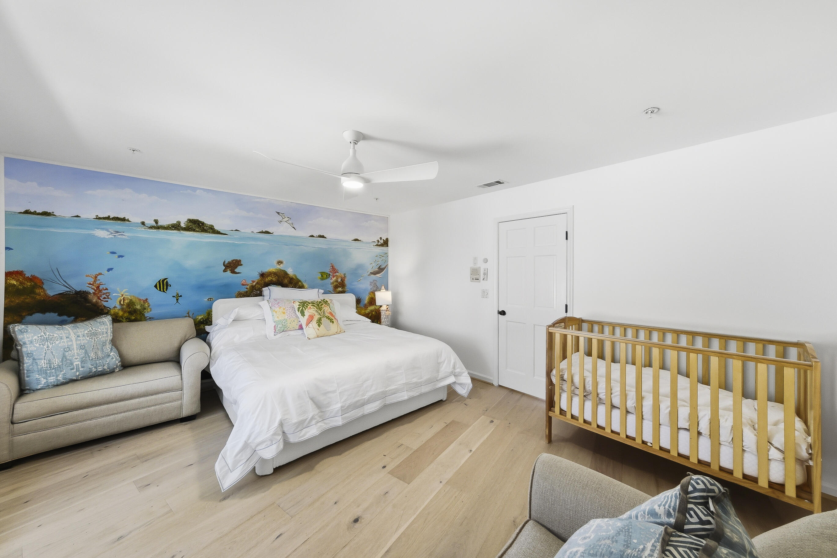 4535 Coquina Road Ocean Ridge, FL 33435 - Photo 21 of 45 a bedroom with a bed and a couch