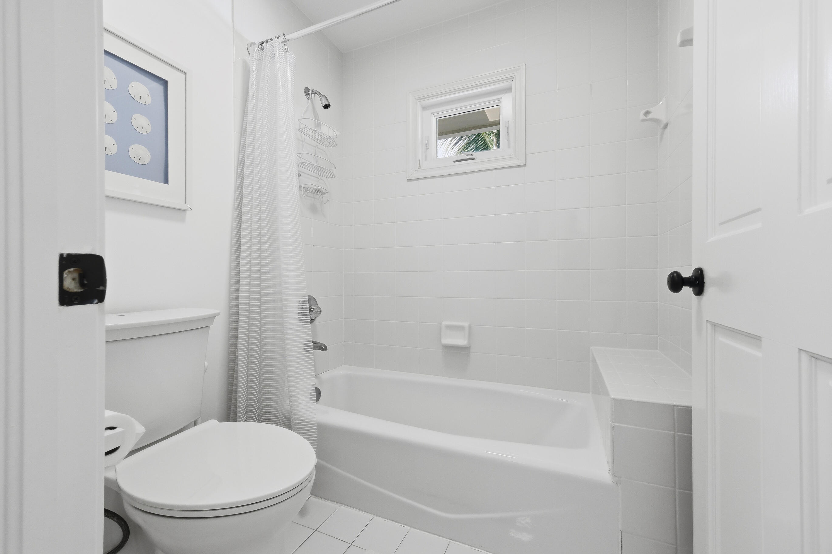 4535 Coquina Road Ocean Ridge, FL 33435 - Photo 24 of 45 a white toilet sitting next to a bath tub