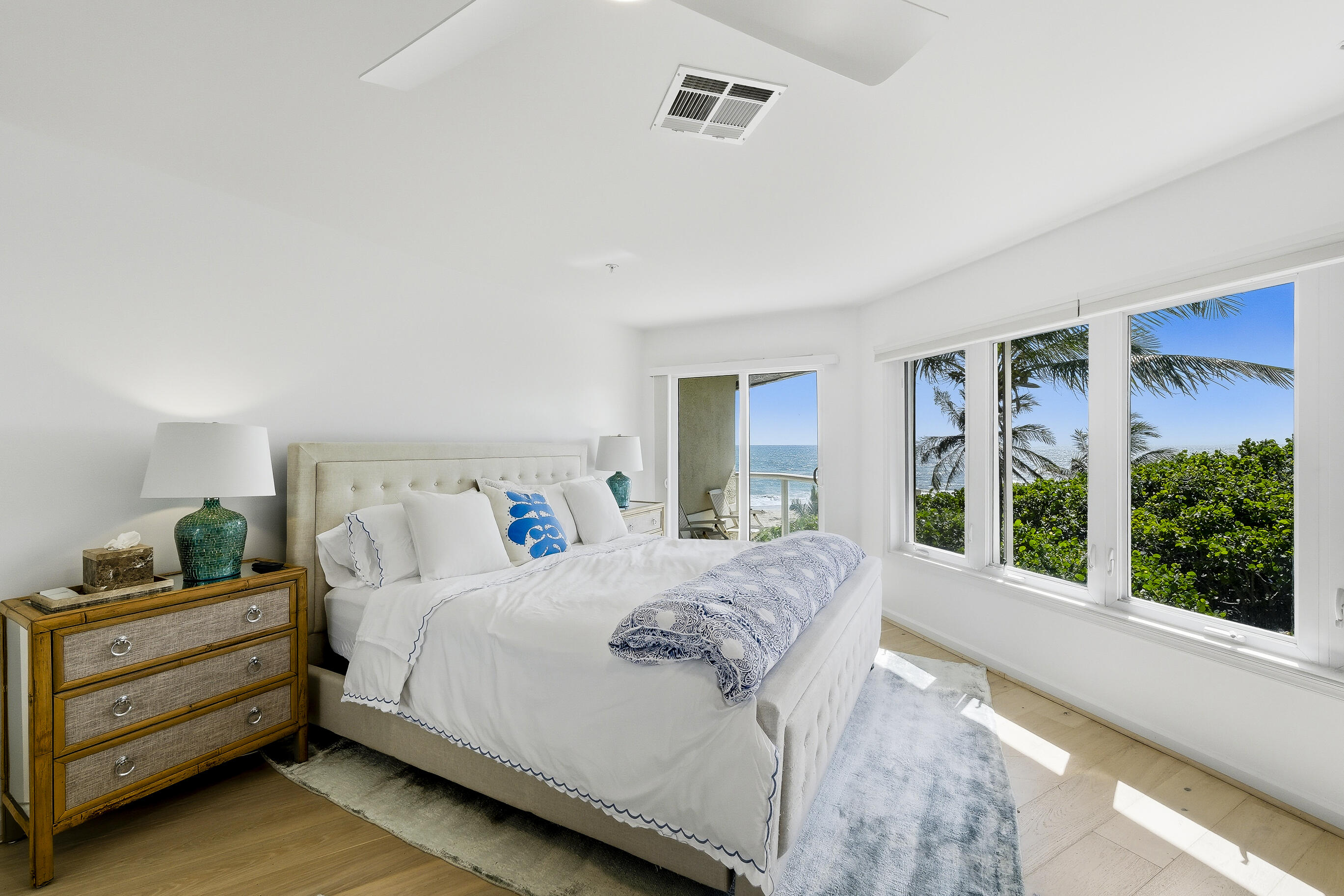 4535 Coquina Road Ocean Ridge, FL 33435 - Photo 27 of 45 a bedroom with a bed and large windows