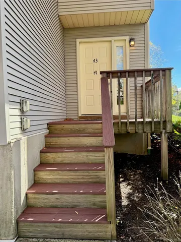 a front view of a house with a chair